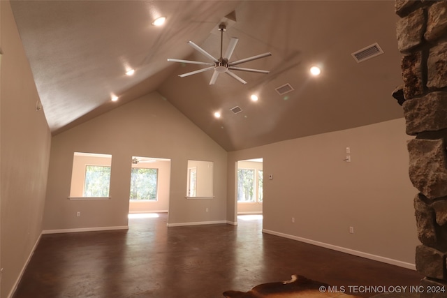 spare room featuring ceiling fan, high vaulted ceiling, and a fireplace