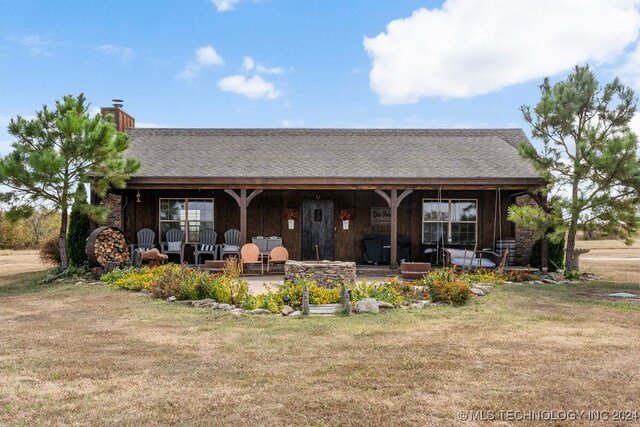 back of house with a yard and a patio area