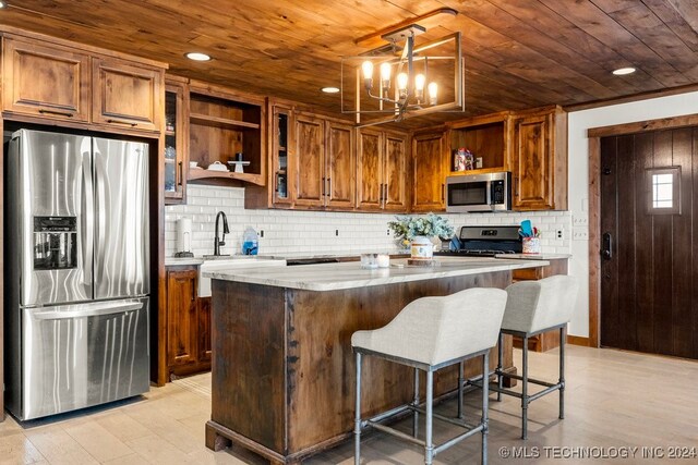 kitchen featuring a center island, wood ceiling, a notable chandelier, hanging light fixtures, and appliances with stainless steel finishes