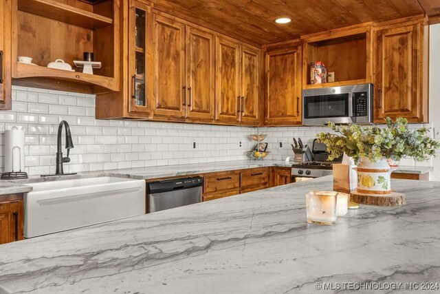 kitchen with tasteful backsplash, wooden ceiling, sink, stainless steel appliances, and light stone countertops