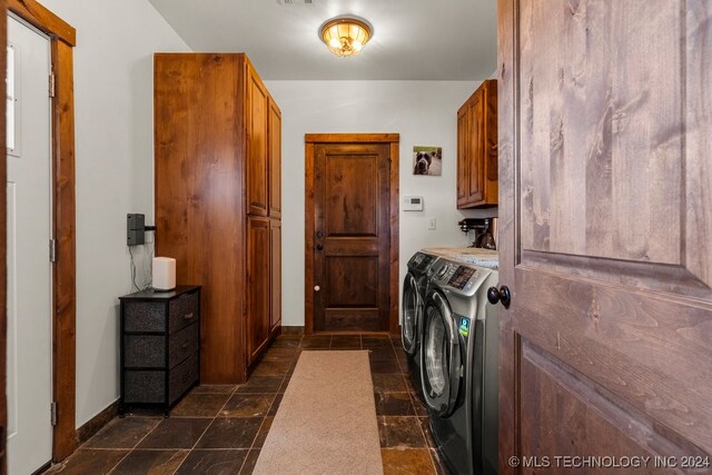 laundry area with separate washer and dryer and cabinets