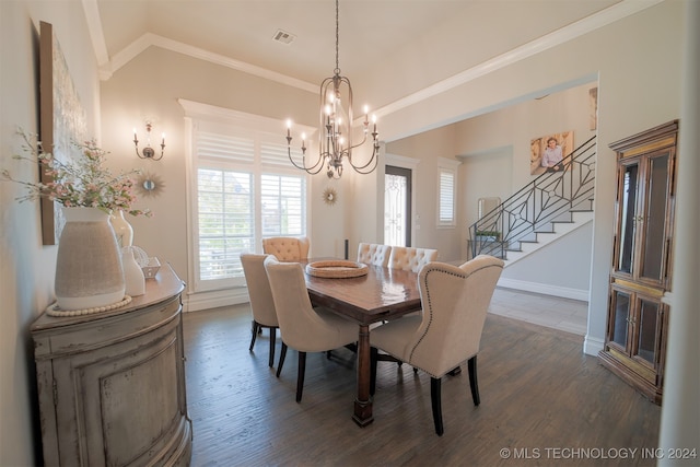 dining area featuring ornamental molding, a notable chandelier, and dark wood-type flooring