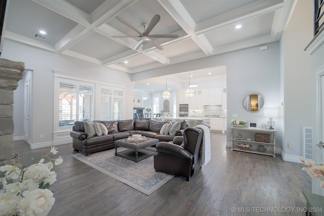 living room with coffered ceiling, beamed ceiling, ceiling fan, and dark wood-type flooring