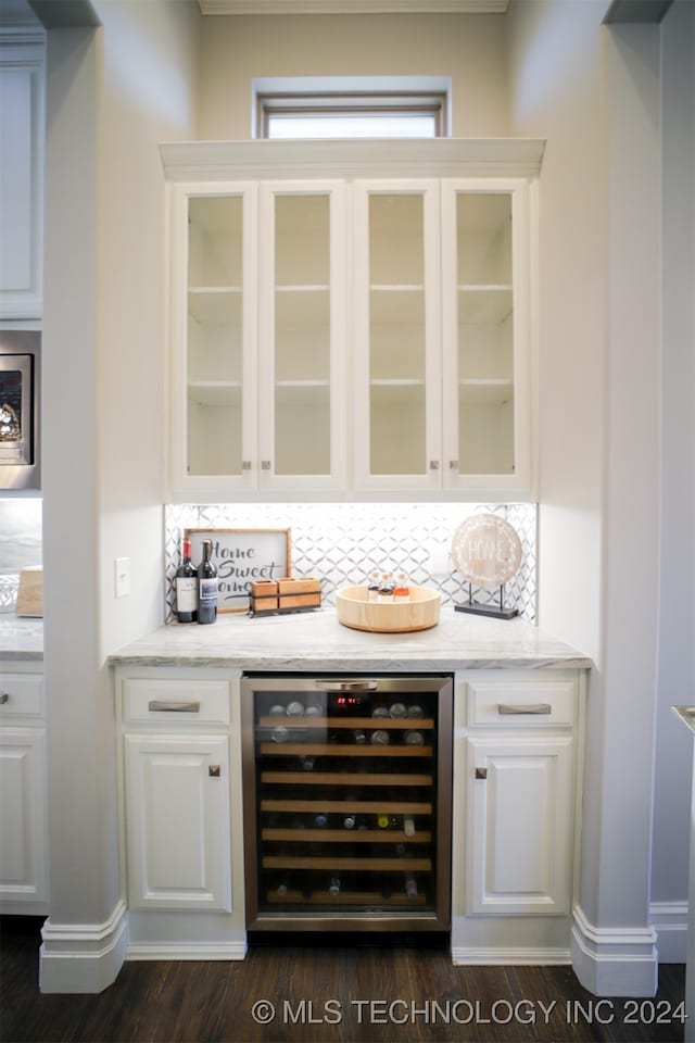 bar featuring backsplash, wine cooler, dark hardwood / wood-style flooring, and white cabinetry