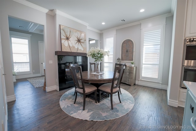 dining space with crown molding and dark wood-type flooring