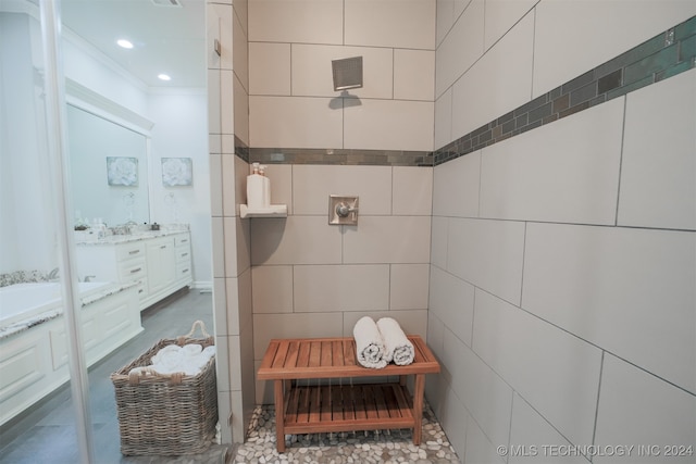 bathroom with crown molding, vanity, and tile walls