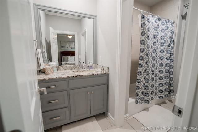 bathroom with ceiling fan, tile patterned floors, shower / tub combo, and vanity