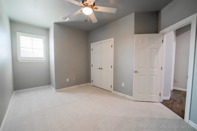 unfurnished bedroom featuring ceiling fan and light colored carpet