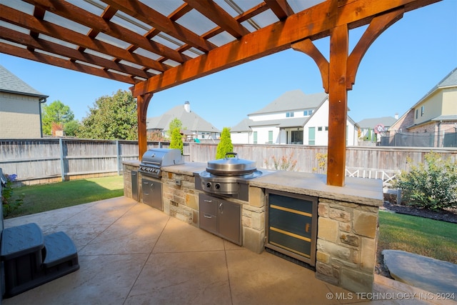 view of patio / terrace with a grill, an outdoor kitchen, and a pergola