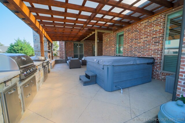 view of patio / terrace featuring exterior kitchen, a pergola, area for grilling, and a hot tub