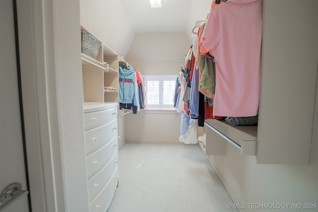 spacious closet with light colored carpet and lofted ceiling