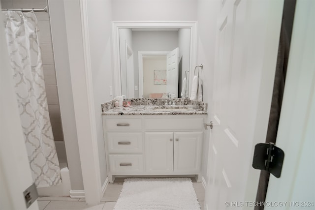 bathroom with shower / bath combination with curtain, tile patterned floors, and vanity