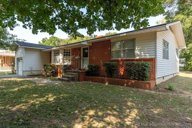 single story home with a garage and a front lawn