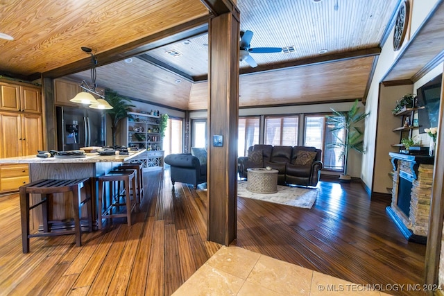 living room featuring dark wood-type flooring, wooden ceiling, and a healthy amount of sunlight