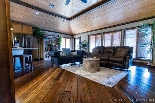 living room with lofted ceiling, dark wood-type flooring, and a wealth of natural light