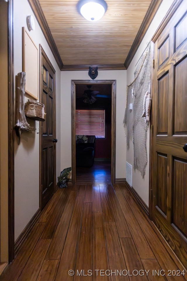 hallway featuring crown molding and dark hardwood / wood-style floors