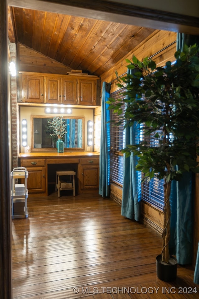 office featuring lofted ceiling, built in desk, wood ceiling, and hardwood / wood-style flooring