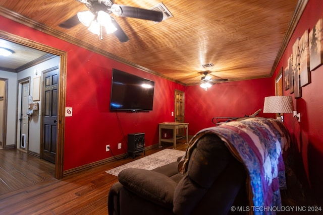 home theater with dark hardwood / wood-style floors, crown molding, and ceiling fan