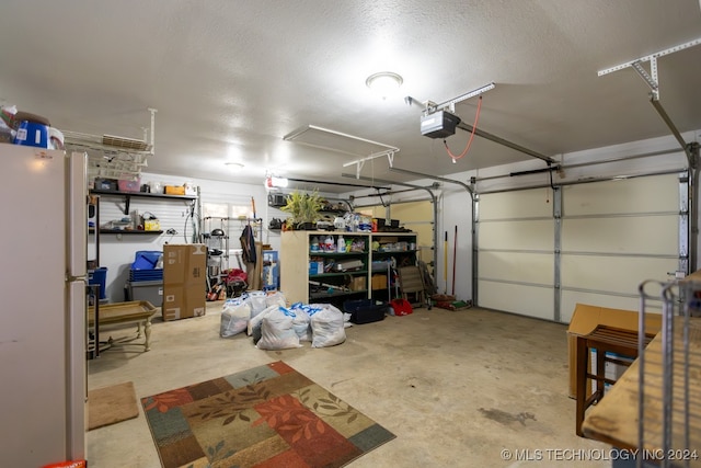 garage with a garage door opener and white fridge