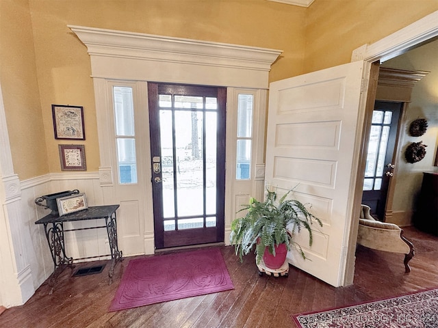 entrance foyer featuring crown molding and wood-type flooring