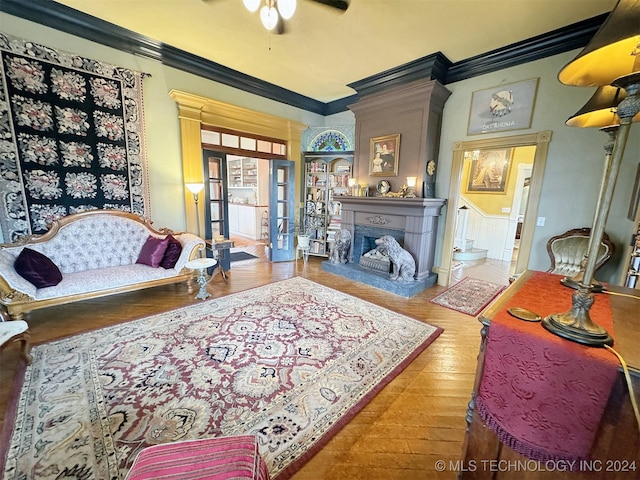 living room featuring crown molding, hardwood / wood-style flooring, and ceiling fan