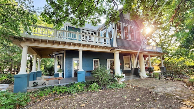 back of house featuring a porch