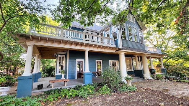 back of property with a porch