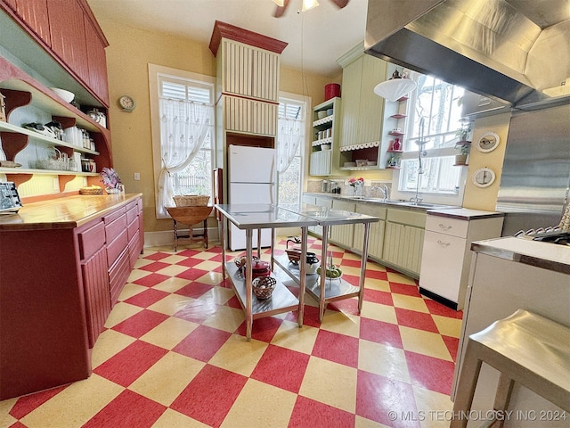 kitchen featuring ventilation hood, white refrigerator, and ceiling fan