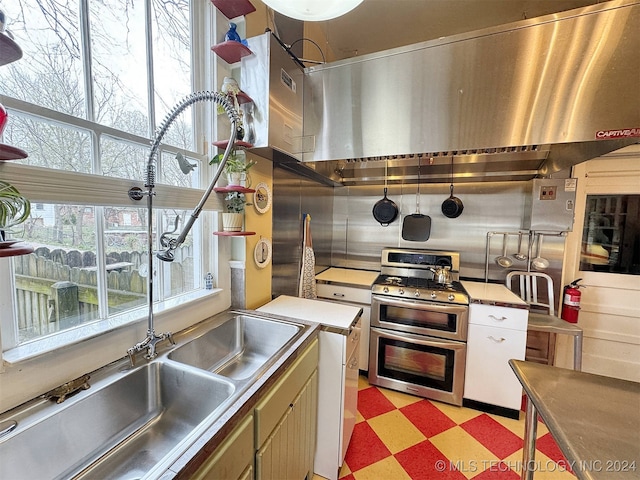 kitchen with ventilation hood and double oven range