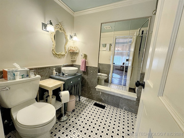 bathroom featuring toilet, crown molding, tile patterned floors, tile walls, and vanity