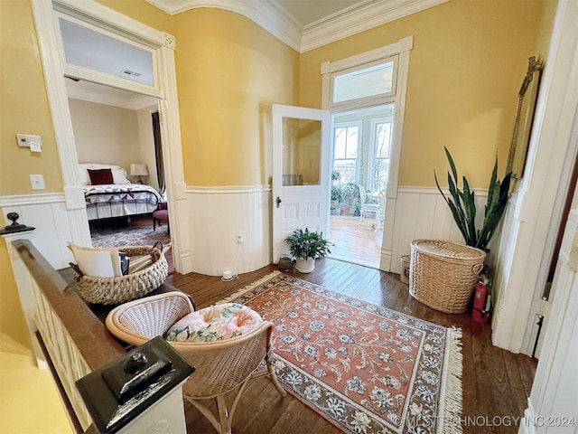 interior space with dark hardwood / wood-style floors and ornamental molding