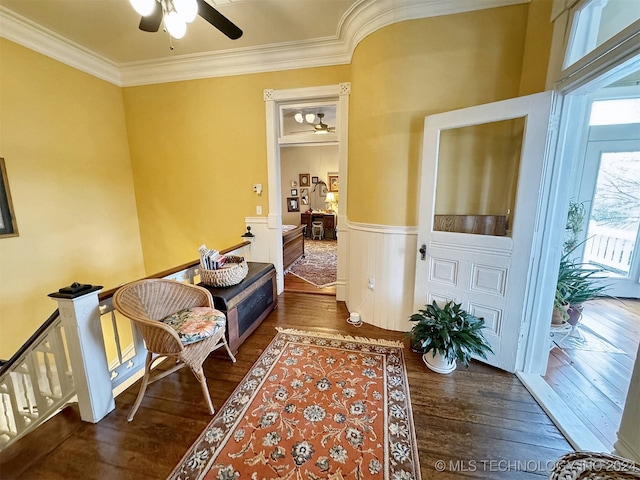 sitting room with crown molding, ceiling fan, and dark wood-type flooring