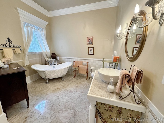 bathroom with ornamental molding, a tub to relax in, vanity, and tile walls