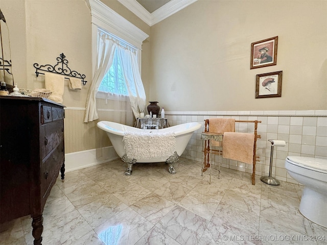 bathroom with a tub, vanity, tile walls, and toilet