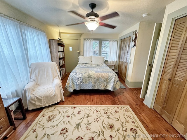 bedroom featuring ceiling fan, a textured ceiling, a closet, and hardwood / wood-style floors