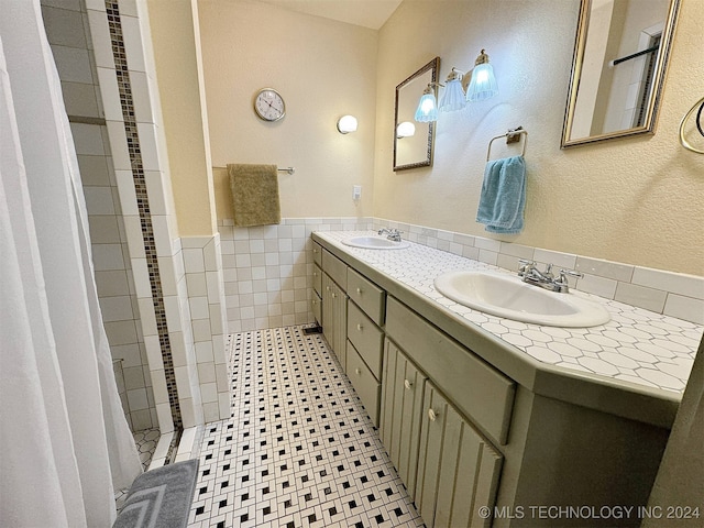 bathroom featuring vanity, tile walls, and a shower with shower curtain