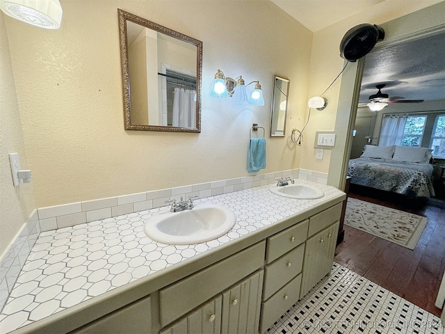 bathroom featuring hardwood / wood-style flooring, ceiling fan, and vanity