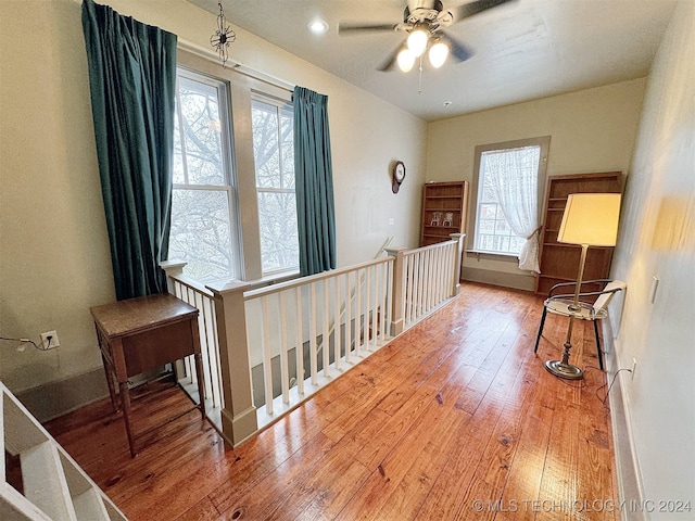 bedroom with wood-type flooring and multiple windows