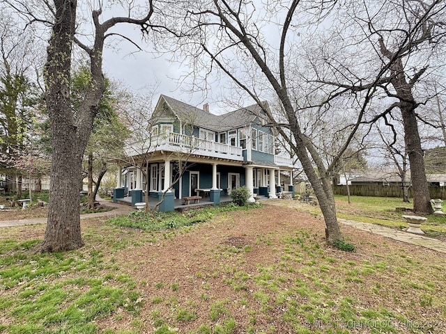 view of front of property with a front yard and a deck