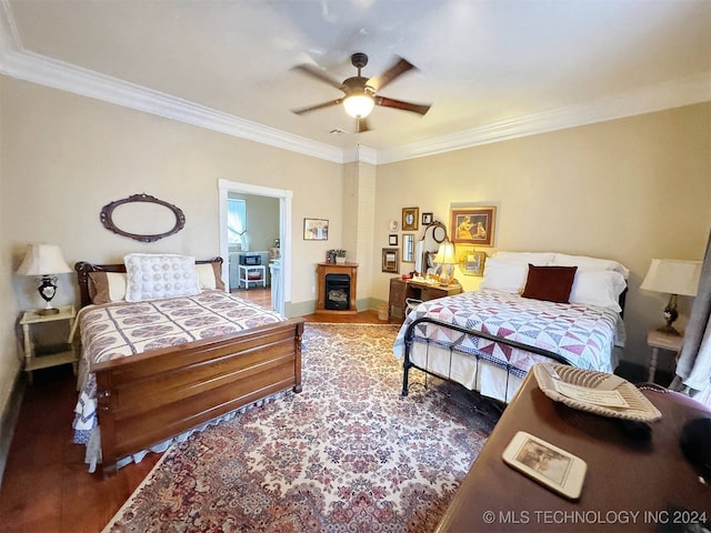 bedroom with crown molding, ceiling fan, and dark hardwood / wood-style flooring