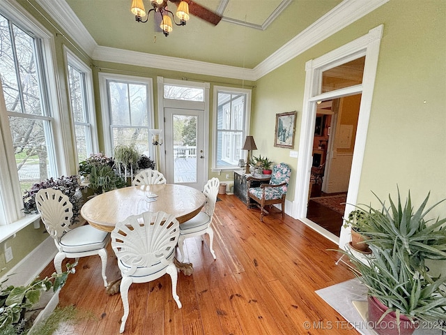 dining space featuring crown molding and light hardwood / wood-style flooring