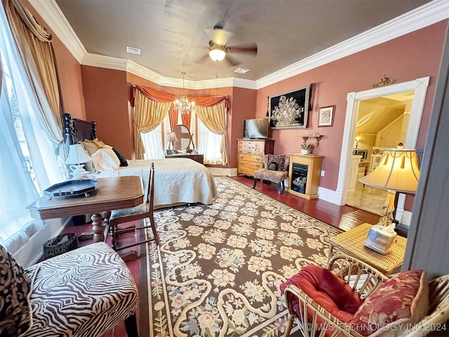 bedroom featuring hardwood / wood-style flooring, ceiling fan with notable chandelier, and ornamental molding