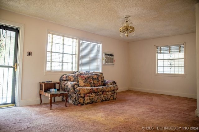 sitting room featuring an AC wall unit, carpet flooring, and a healthy amount of sunlight