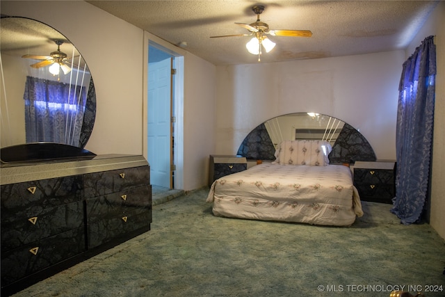 carpeted bedroom featuring a textured ceiling and ceiling fan