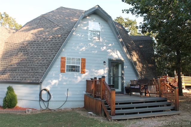 back of property with a wooden deck