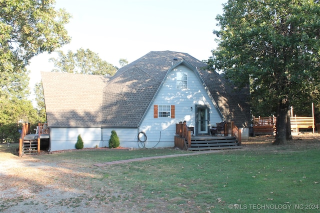 rear view of house with a yard