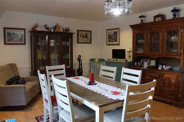 dining space featuring an inviting chandelier and light hardwood / wood-style floors