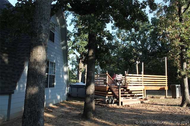 view of side of home with a wooden deck