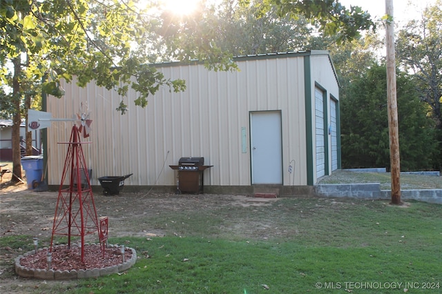 view of outbuilding with a yard and a garage