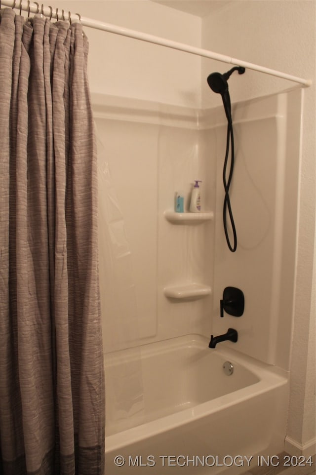 bathroom with shower / bathtub combination with curtain